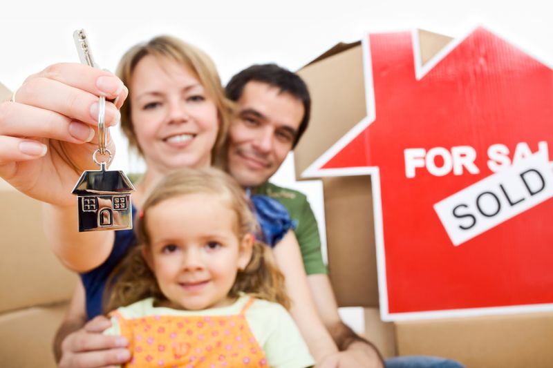 Happy family with keys to new home